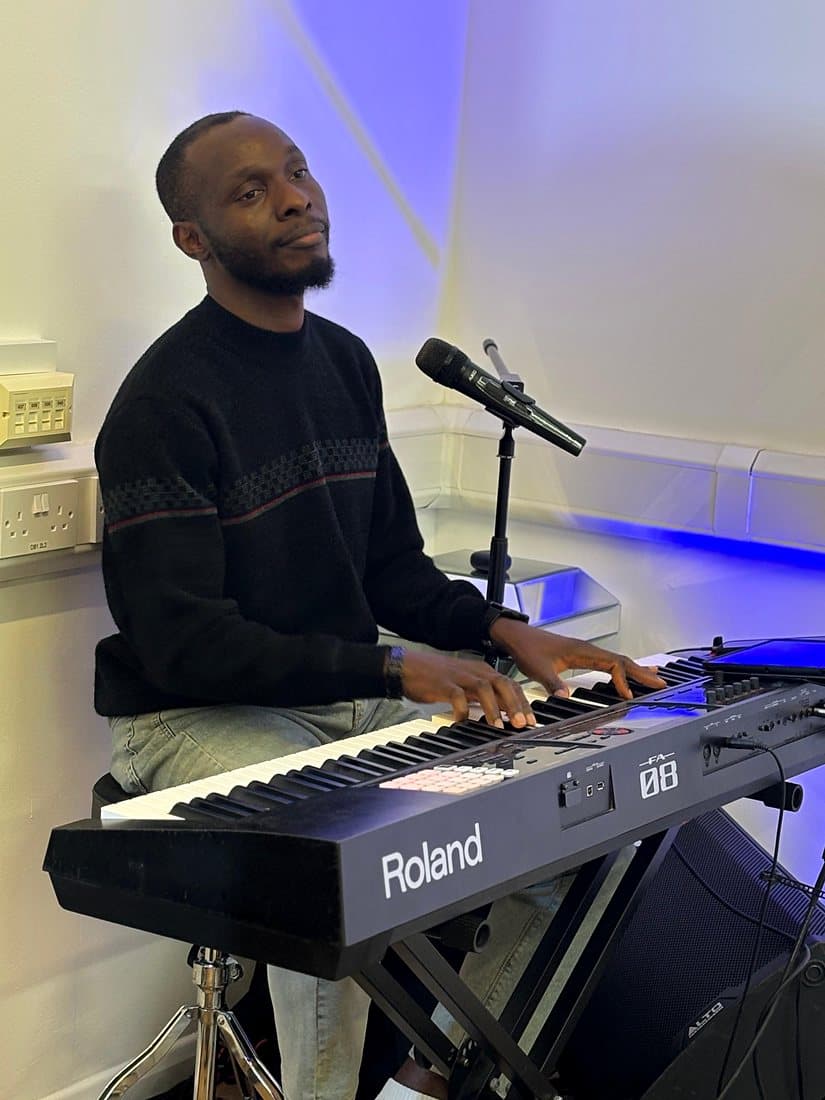 A musician playing the keyboard during worship