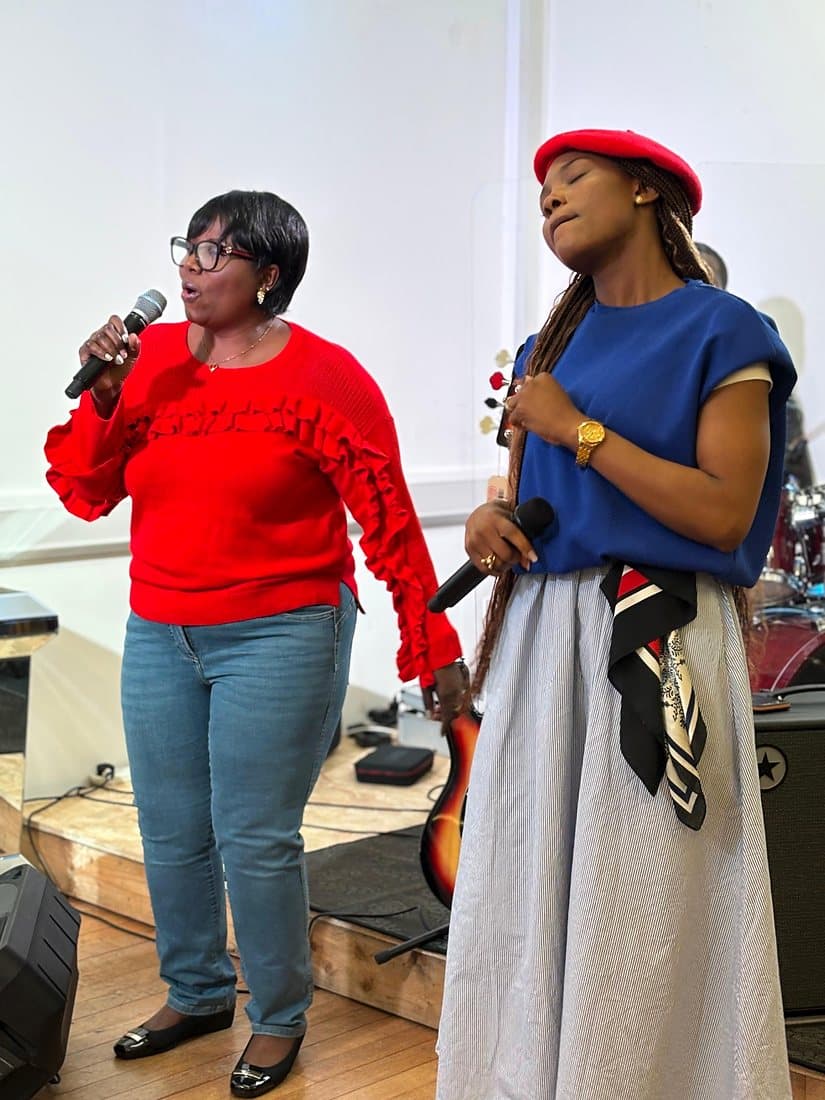 Two women singing on the worship team